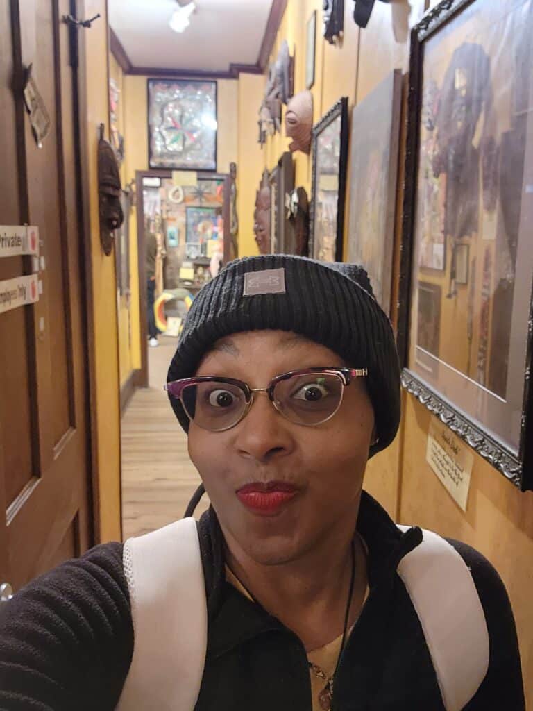 Black woman standing in a hallway in a museum.